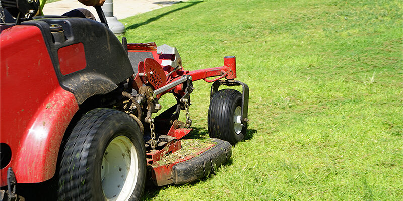 Person driving an industrial lawn mower